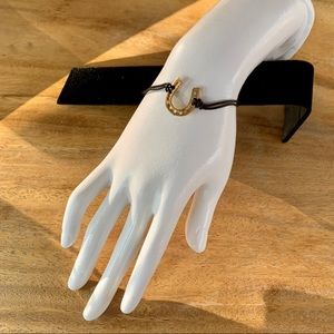 Golden Horseshoe bracelet on adjustable leather cord